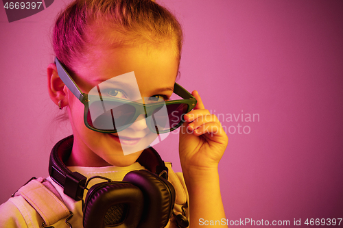 Image of Young girl with headphones enjoying music