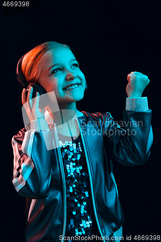 Image of Young girl with headphones enjoying music