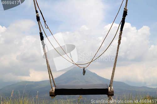 Image of Wooden swing on the rope with view of Batur volcano 