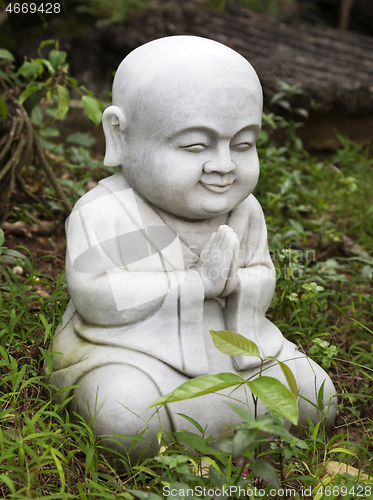 Image of Small Buddha statue in a garden