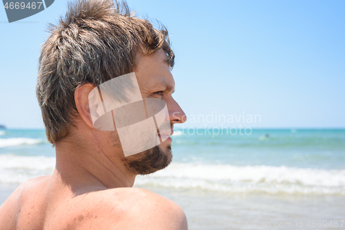 Image of Portrait of an overgrown man of forty years against the background of the sea