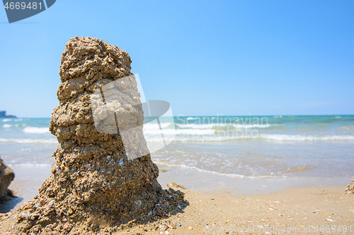 Image of A pile of wet sand on the seashore, on the right there is an empty place for inscription