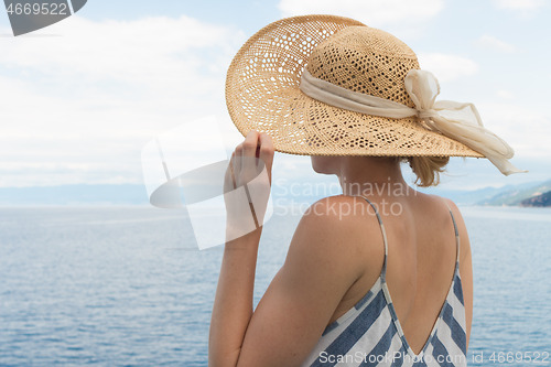 Image of Beautiful, romantic blonde woman taking selfie self portrait photo on summer vacations traveling by cruse ship ferry boat.