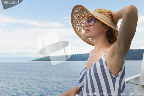 Image of Beautiful, romantic blonde woman taking selfie self portrait photo on summer vacations traveling by cruse ship ferry boat.