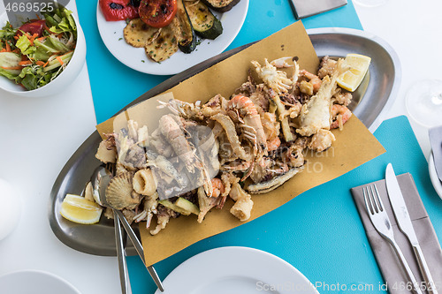 Image of Delicious fried sea food plate for two on summer vacation in traditional croatian costal restorant by the sea.