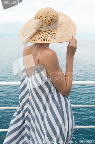 Image of Beautiful, romantic blonde woman taking selfie self portrait photo on summer vacations traveling by cruse ship ferry boat.