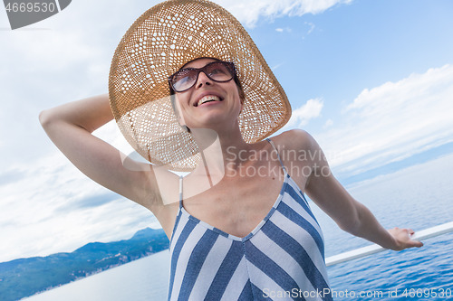 Image of Beautiful, romantic blonde woman taking selfie self portrait photo on summer vacations traveling by cruse ship ferry boat.