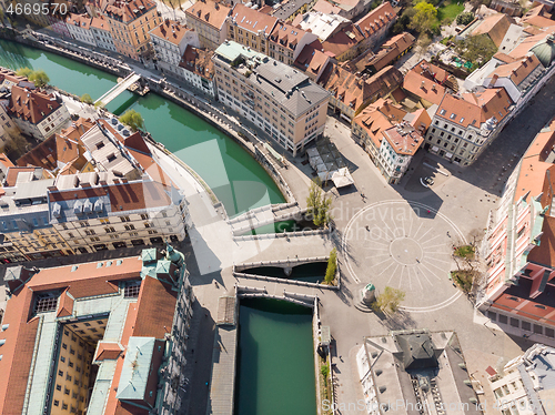 Image of Aerial drone view of Preseren Squere and Triple Bridge over Ljubljanica river,Tromostovje, Ljubljana, Slovenia. Empty streets during corona virus pandemic social distancing measures