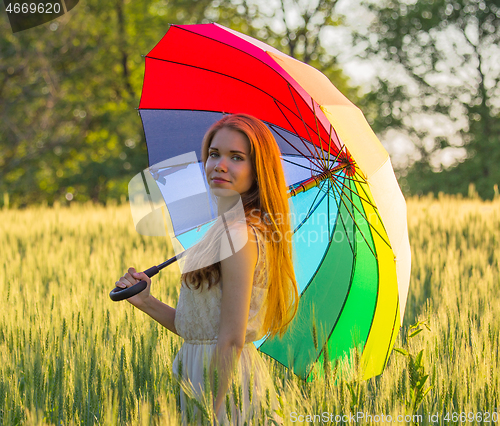 Image of Cute girl with a multicolored umbrella