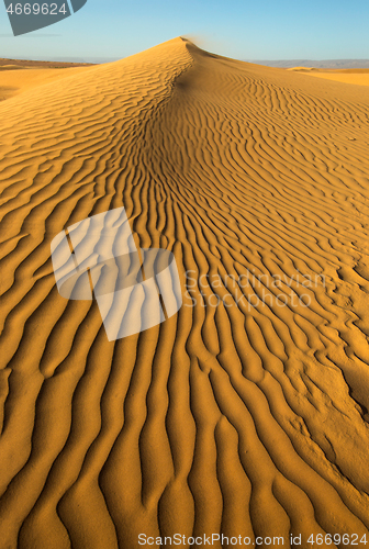 Image of Sand blowing over sand dunes in wind