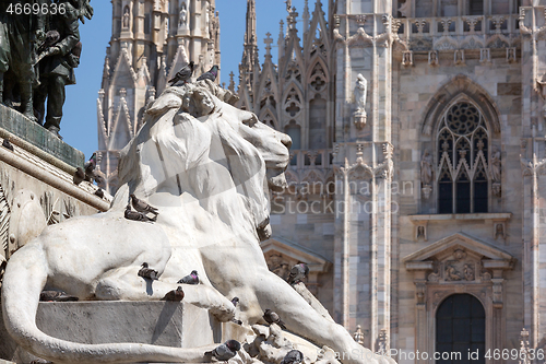 Image of Lion statue and cathedral in Milan