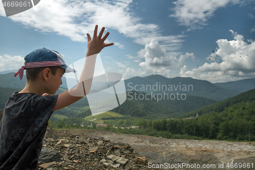 Image of Boy throwing roks