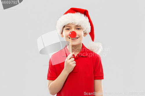 Image of smiling boy in red t-shirt and santa helper hat