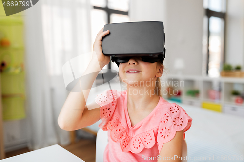 Image of girl in vr glasses at home