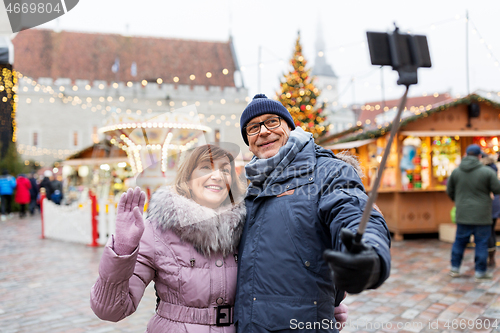 Image of senior couple taking selfie at christmas market