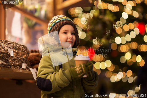 Image of happy boy with cup of tea at christmas market