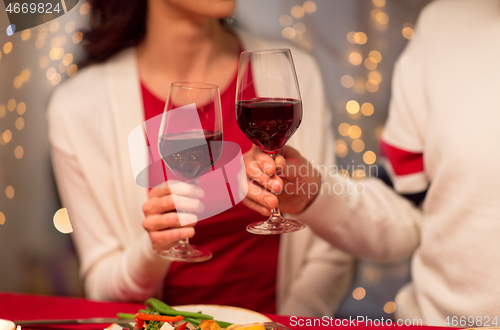 Image of close up of couple drinking red wine on christmas