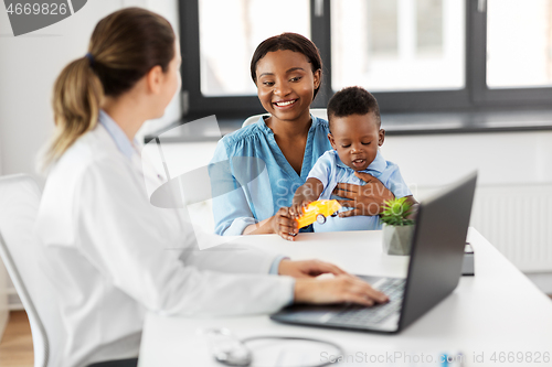 Image of happy mother with baby son and doctor at clinic