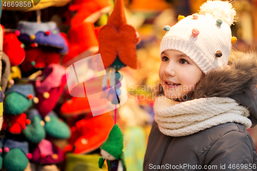 Image of happy little girl at christmas market in winter