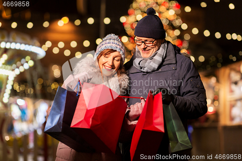 Image of old couple at christmas market with shopping bags