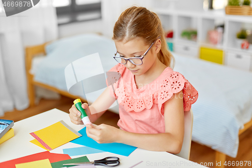 Image of creative girl making greeting card at home