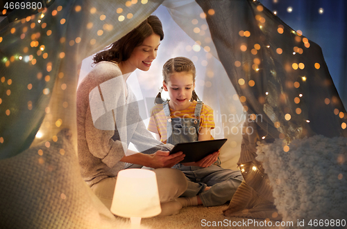 Image of family with tablet pc in kids tent at home