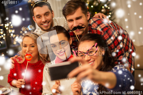 Image of friends taking selfie at christmas dinner