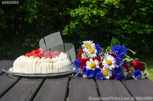 Image of Cream cake and summer flowers