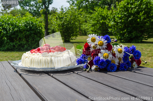 Image of Green garden with cream cake and flowers