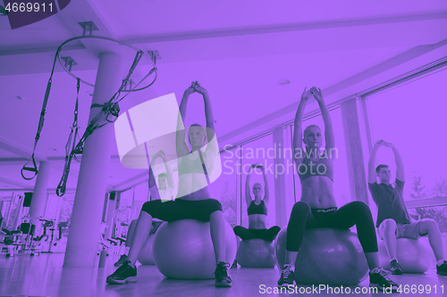 Image of group of people exercise with balls on yoga class