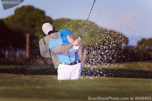 Image of pro golfer hitting a sand bunker shot