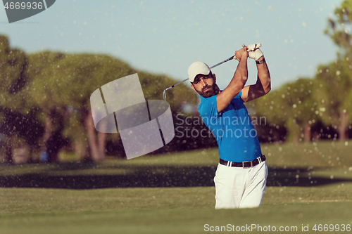 Image of pro golfer hitting a sand bunker shot