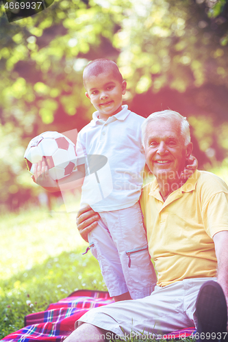 Image of grandfather and child have fun  in park