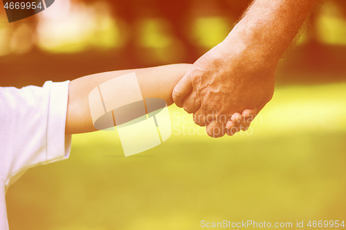 Image of grandfather and child have fun  in park