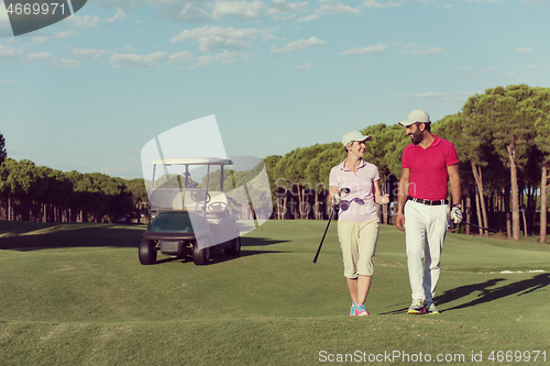 Image of couple walking on golf course