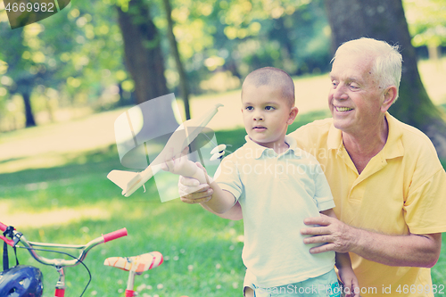 Image of happy grandfather and child in park
