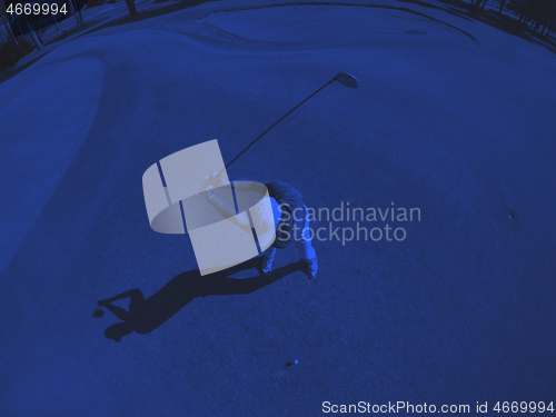 Image of top view of golf player hitting shot