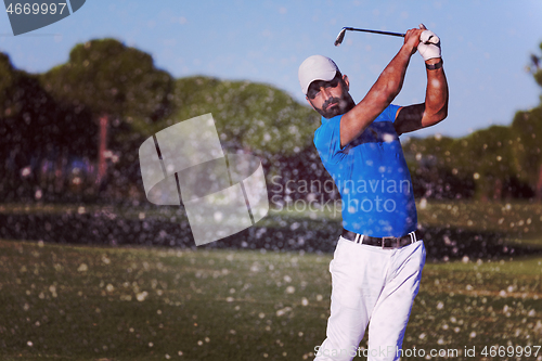 Image of pro golfer hitting a sand bunker shot