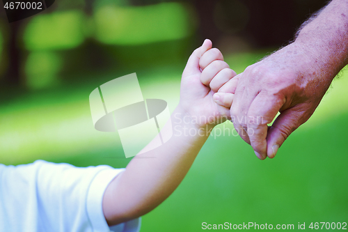 Image of happy grandfather and child in park