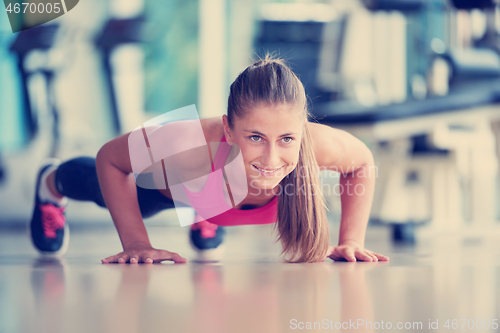 Image of warming up and doing some push ups a the gym