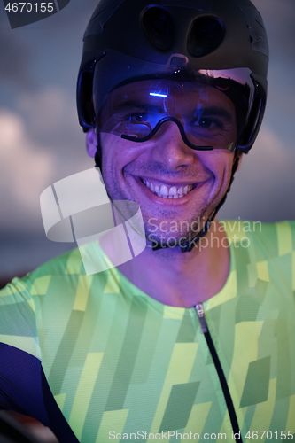 Image of triathlon athlete portrait while resting on bike training