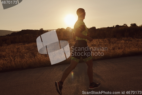 Image of triathlon athlete running on morning trainig