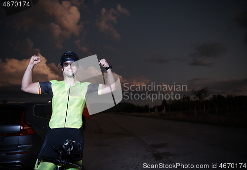 Image of triathlon athlete portrait while resting on bike training