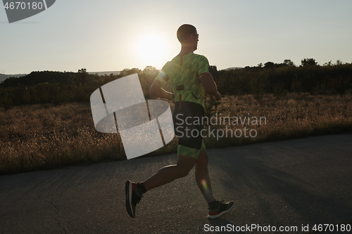 Image of triathlon athlete running on morning trainig