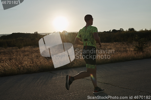 Image of triathlon athlete running on morning trainig