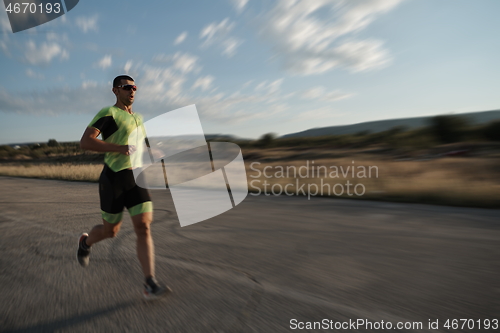 Image of triathlon athlete running on morning trainig