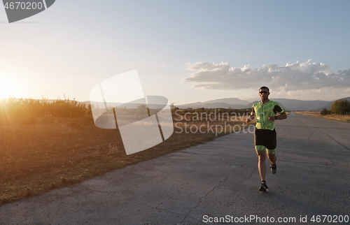 Image of triathlon athlete running on morning trainig