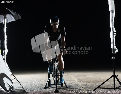 Image of triathlon athlete portrait while resting on bike training