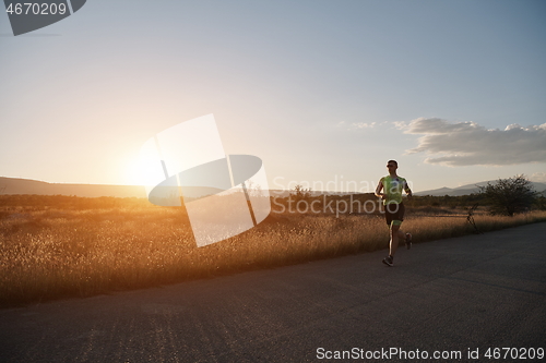 Image of triathlon athlete running on morning trainig