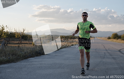 Image of triathlon athlete running on morning trainig